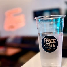 Free State Coffee Co branded cup on the counter