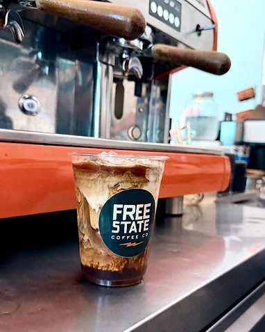 Free State Coffee Co iced coffee on the orange Wega espresso machine