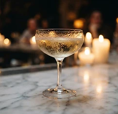 A coupe of champagne beaded with condensation