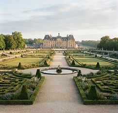 A formal French garden at a chateau with manicured hedges
