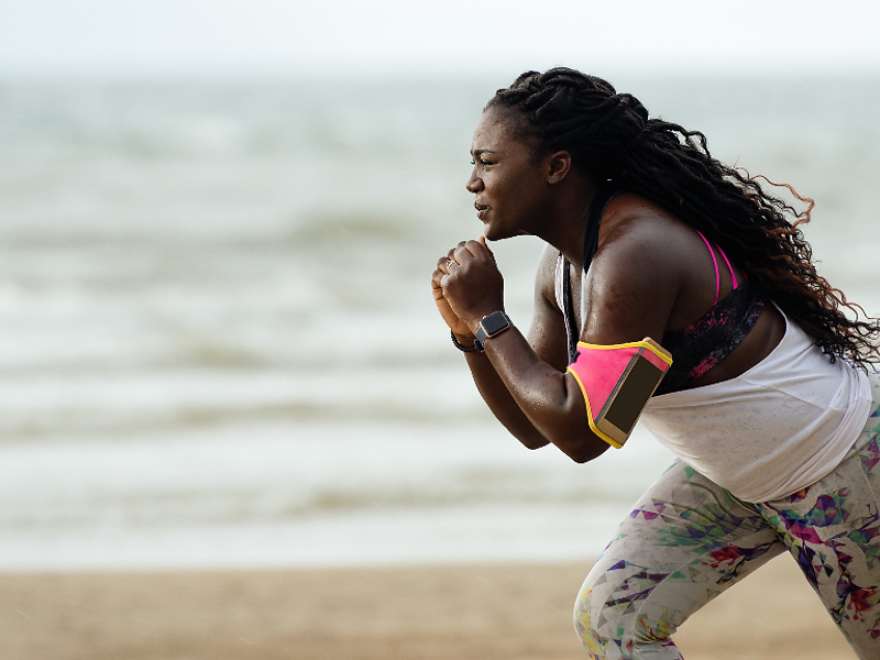 A woman in motion on the beach, embodying hope and the pursuit of healthier generations