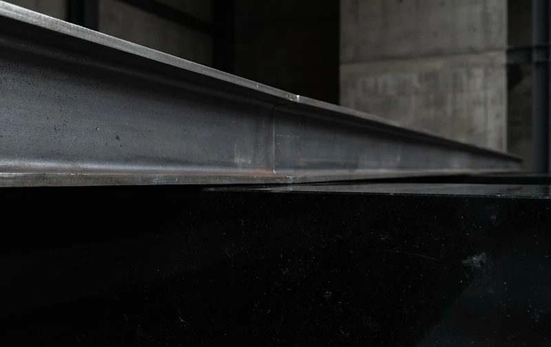 Structural steel beam meeting obsidian