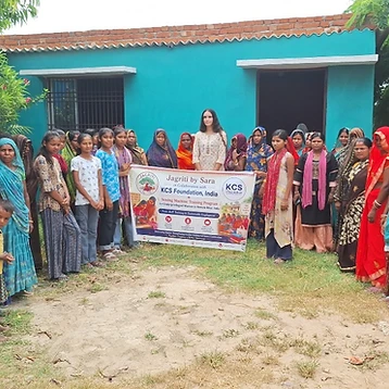 Group portrait with the Sewing Machine Training Program banner