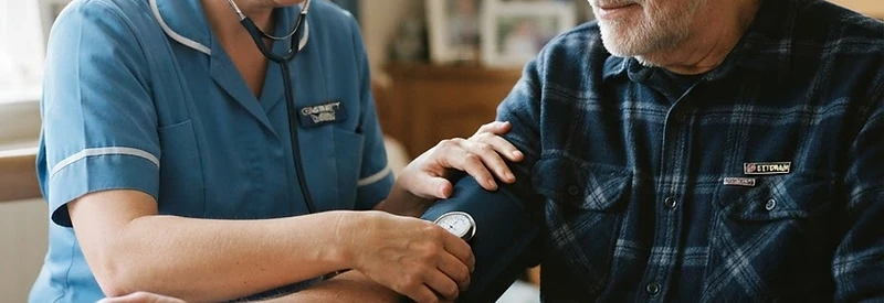 Community nurse checking a veteran's blood pressure with calm, steady hands