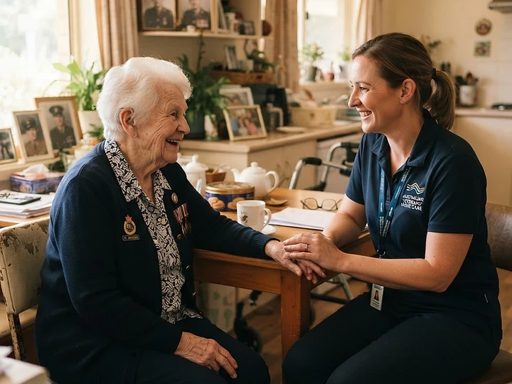 Community nurse chatting warmly with a veteran at their kitchen table