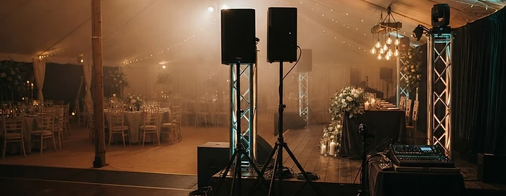 Intimate estate wedding reception with warm uplighting