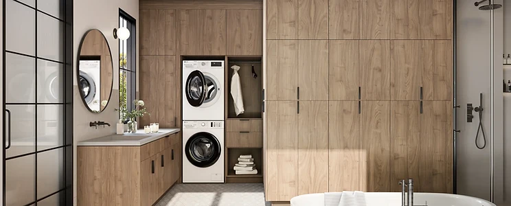 Modern full-height bathroom storage with wood-grain cabinetry, integrated laundry center and freestanding tub