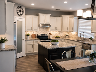 Kitchen with white cabinets and black island after refresh