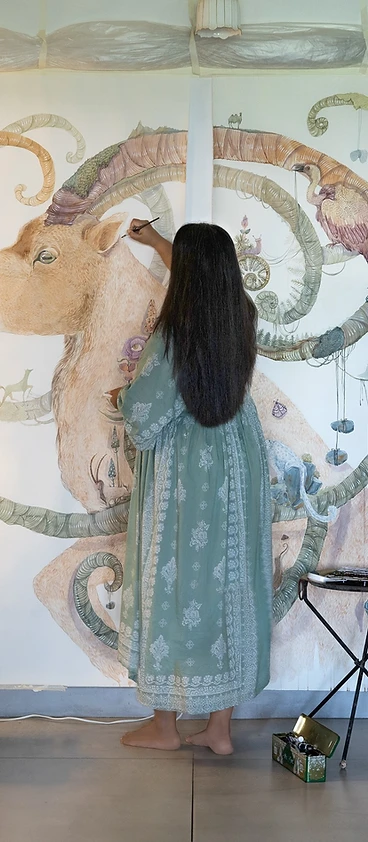 A watercolour artist painting a large-scale mural