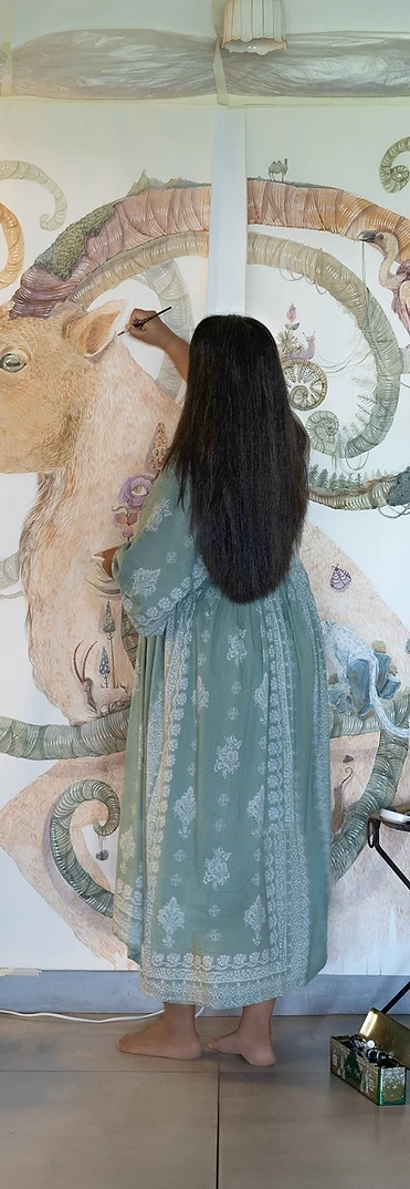 A watercolour artist painting a large-scale mural