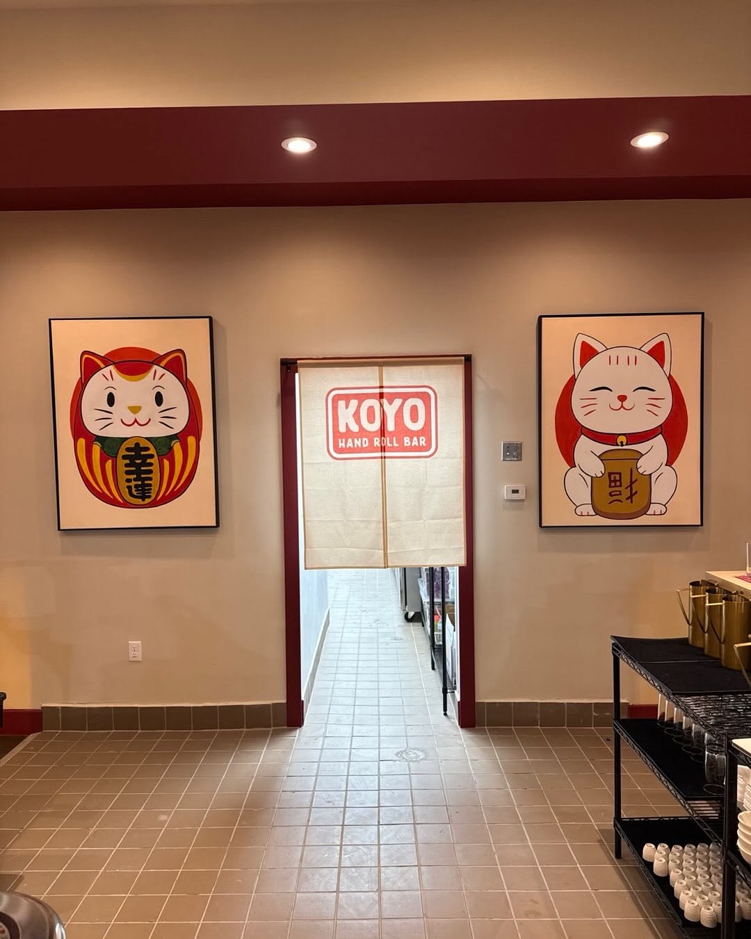 Restaurant interior with a deep-red painted accent stripe and trim at Koyo Hand Roll Bar by Arc Painting Solutions