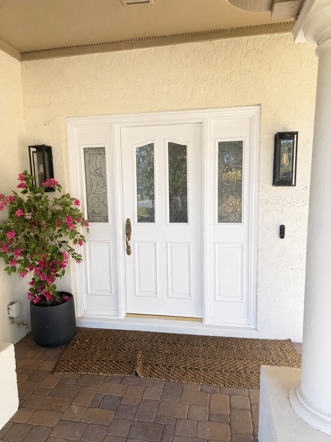 White entry door with glass sidelights by Arc Painting Solutions in The Woodlands, TX