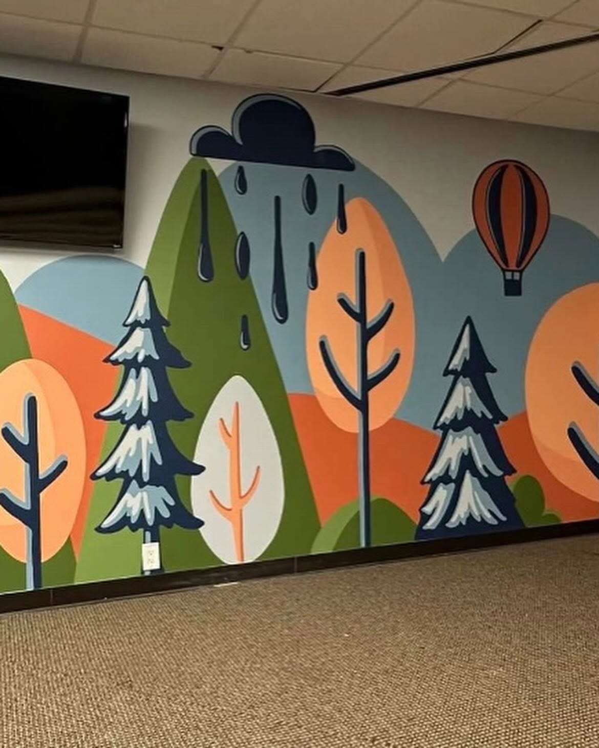Rolling hills and hot air balloon mural hand-painted in an office hallway by Arc Painting Solutions