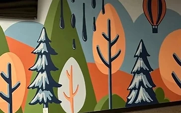 Hand-painted rolling hills mural with hot air balloon by Arc Painting Solutions