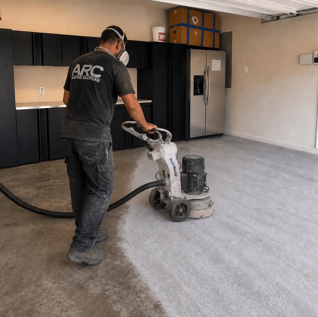 Diamond-grinding a garage floor to prep for epoxy coating by Arc Painting Solutions in The Woodlands, TX