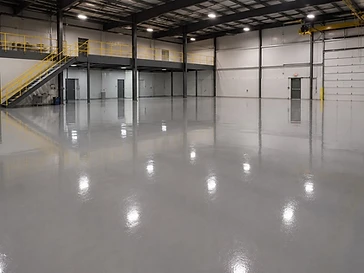 High-gloss sealed epoxy floor with mirror reflections installed by Arc Painting Solutions