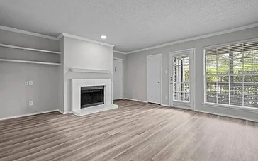 Bright grey living room with fresh white trim after an interior painting project by Arc Painting Solutions