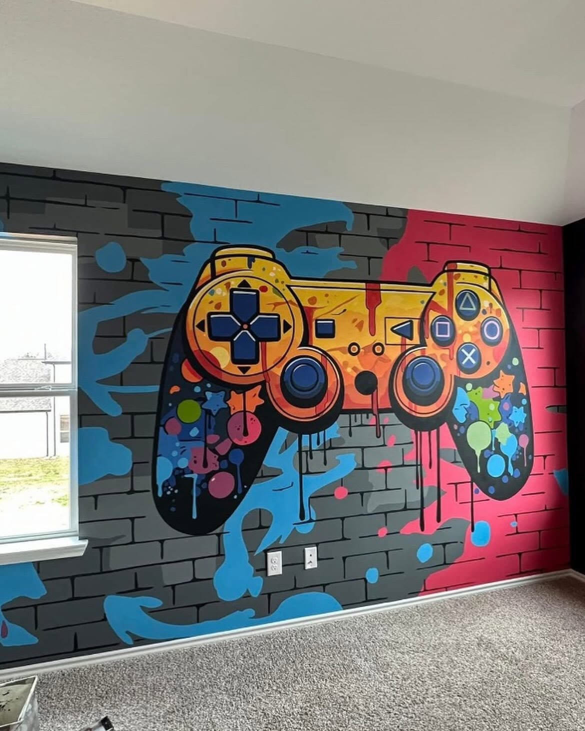 Colorful game controller mural hand-painted on a faux-brick bedroom wall by Arc Painting Solutions