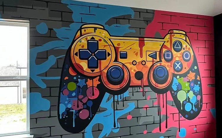 Colorful game controller mural hand-painted on a faux-brick bedroom wall by Arc Painting Solutions
