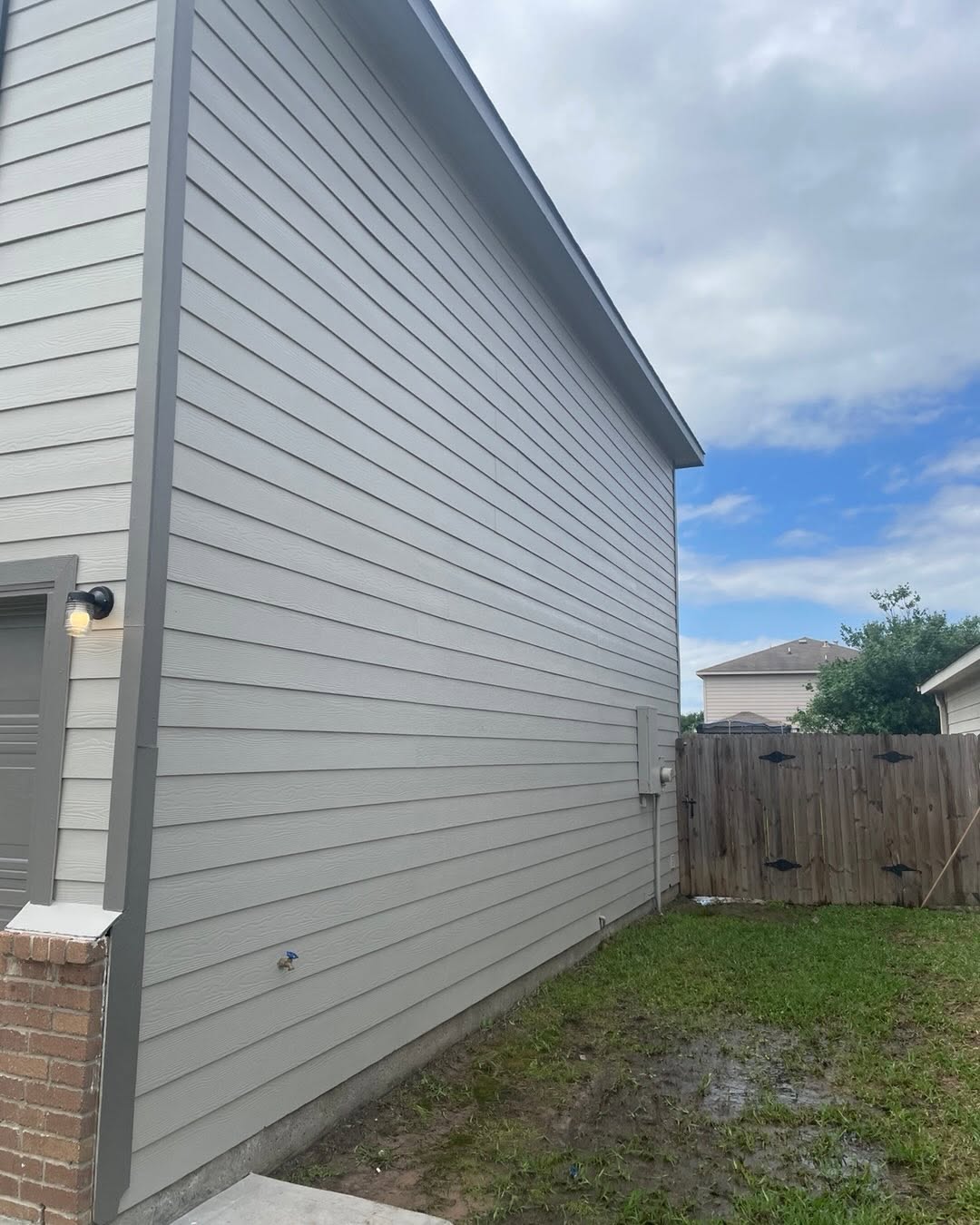 Freshly painted grey lap siding exterior by Arc Painting Solutions in The Woodlands, TX