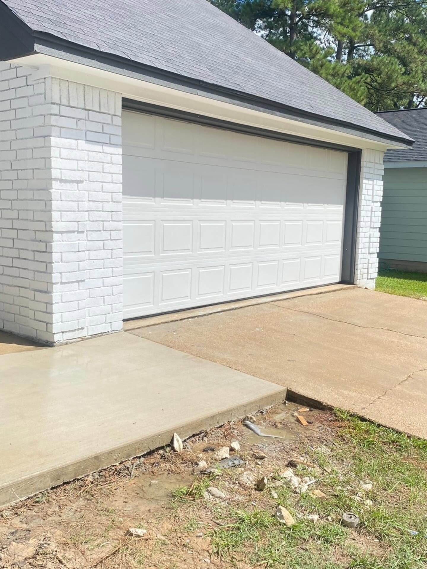 Freshly painted garage exterior and brick walls by Arc Painting Solutions in The Woodlands, TX
