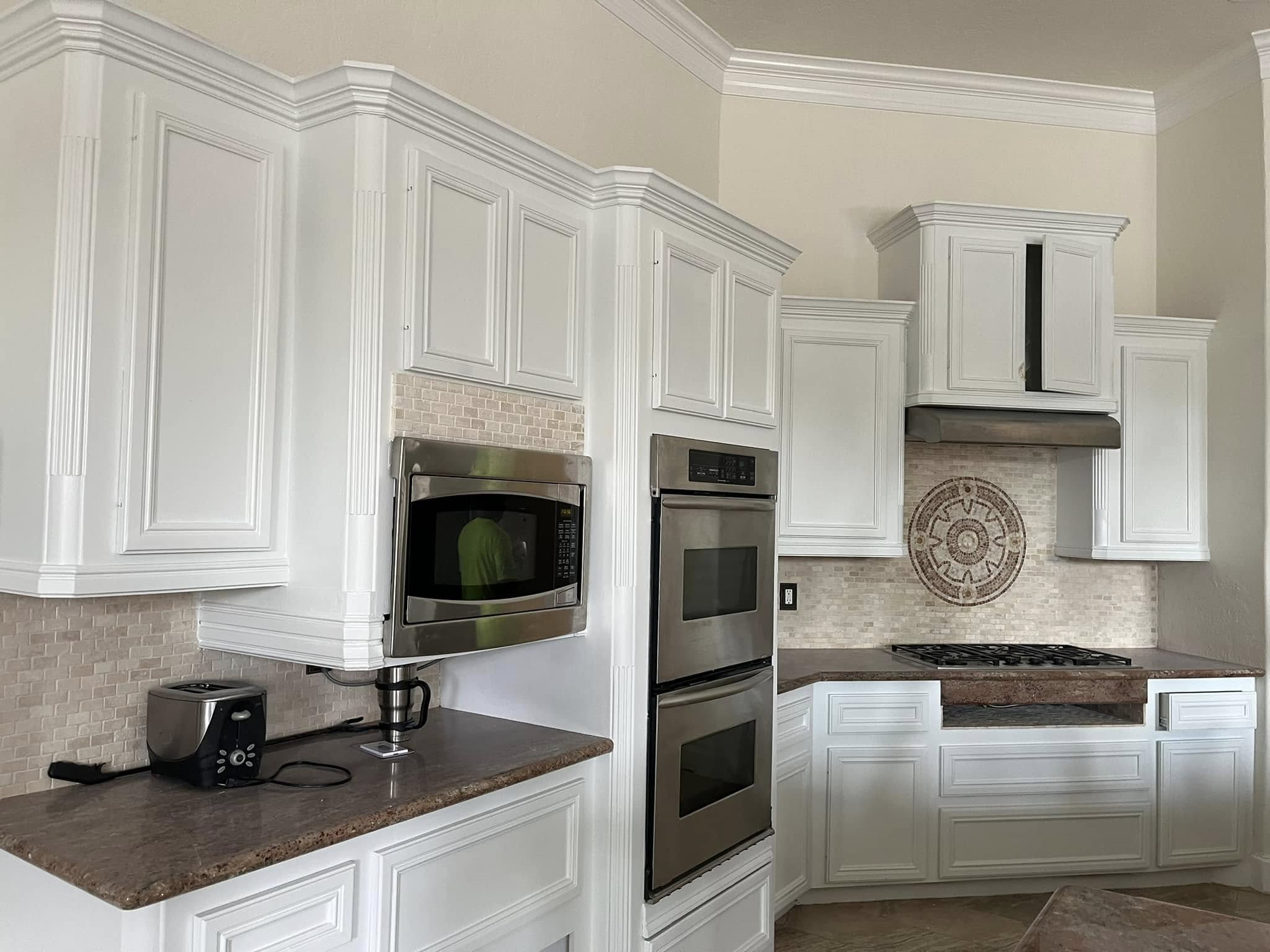 Sprayed cabinet repaint with crisp white shaker finish by Arc Painting Solutions in The Woodlands, TX