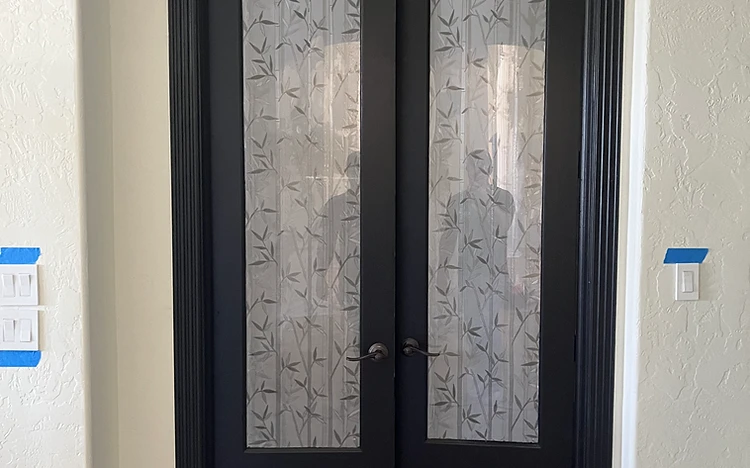 Matte black French doors with patterned glass painted by Arc Painting Solutions in Spring, TX