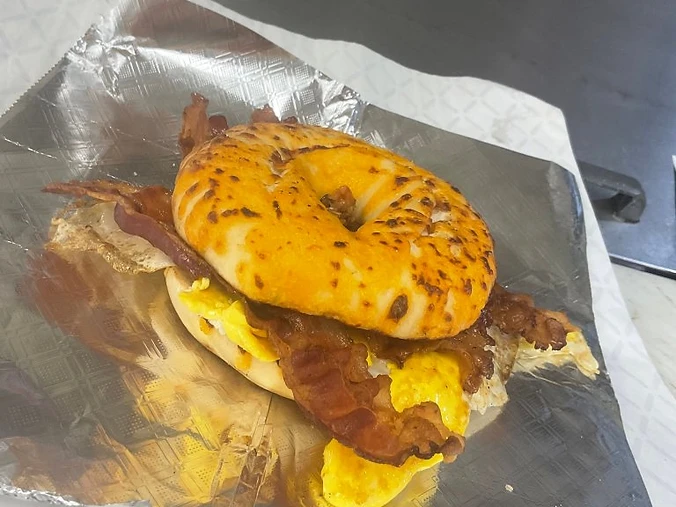 Bacon, egg, and cheese breakfast sandwich on a seasoned bagel at Jack's Market