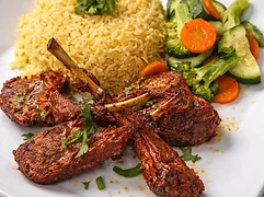 Seasoned entrée served with rice and vegetables