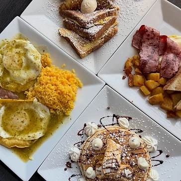 Four breakfast plates arranged together on a table