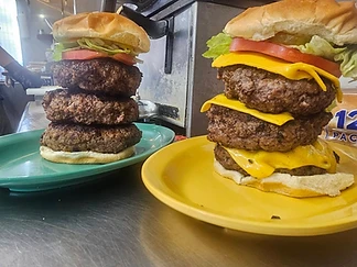 Two tall stacked burgers on colorful plates in the Small’s kitchen