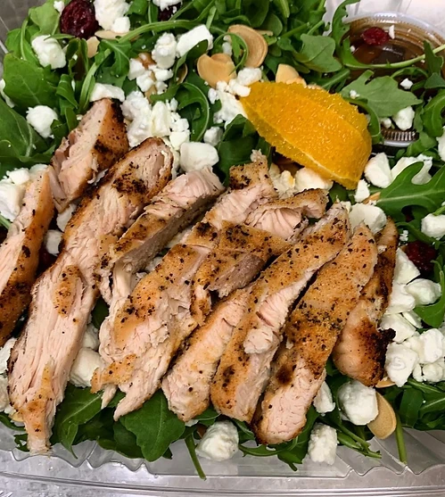 Prepared salad with grilled protein and greens