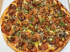 Large pizza with assorted meat and vegetable toppings