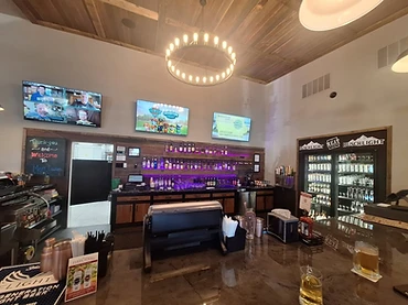 The Meat Locker bar interior with warm wood ceiling and stocked bar