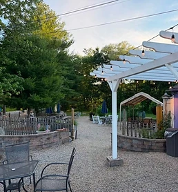 Seasonal outdoor seating beneath the pergola