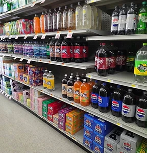 Market aisle stocked with bottled and packaged beverages