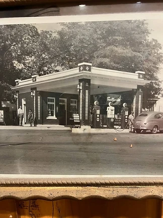 Black-and-white historic Gulfpride gas station photograph displayed at Angie’s