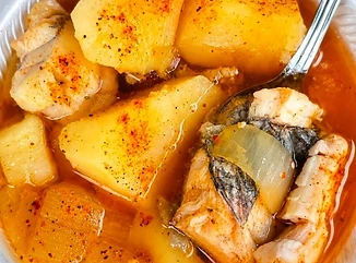 Bowl of catfish stew with fish and potatoes
