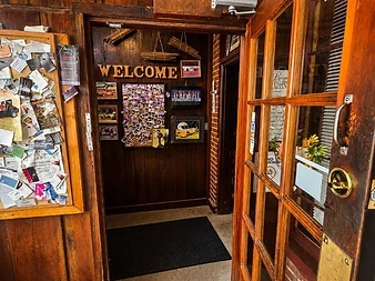 Wood-paneled welcome entrance inside Angie’s Steak & Seafood