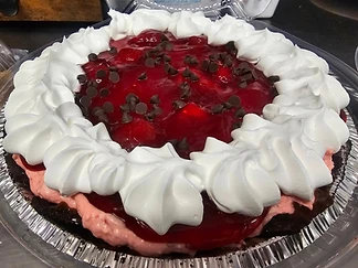 Fruit-topped pie finished with whipped cream and chocolate chips
