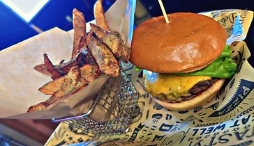 A Tavern on 66 cheeseburger served with seasoned fries