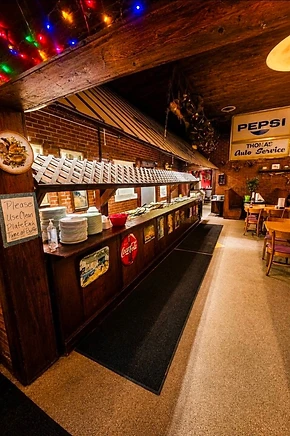 Rustic buffet line and dining room at Angie’s Steak & Seafood