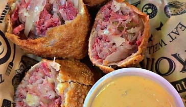 Crisp Reuben-style egg rolls served with dipping sauce