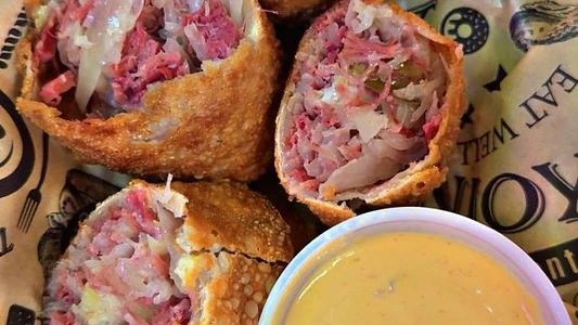 Crisp Reuben-style egg rolls served with dipping sauce