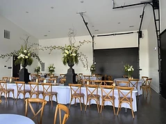 Styled event room with tables and floral arrangements