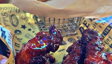 Sauced chicken wings served with shareable fried tavern bites