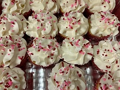 Seasonally decorated cupcakes with pink and red sprinkles