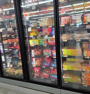 Glass-door freezer cases with frozen pizza and other frozen foods