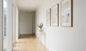 Example of framed artworks hung in a row along a hallway