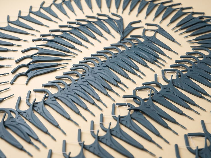 Collection of blue-grey orthodontic braces floss picks arranged in a fan